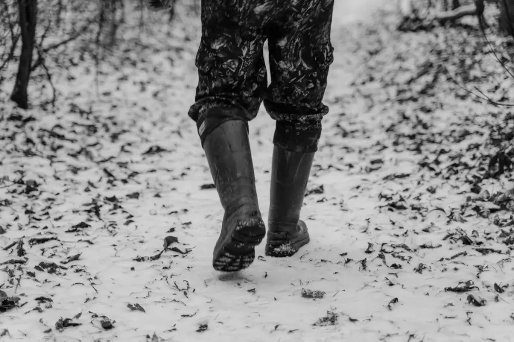man walking on a footpath covered with snow